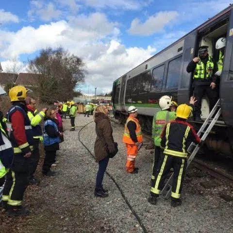 Volunteers in hi-vis at a multi-agency rail incident exercise alongside fire crews