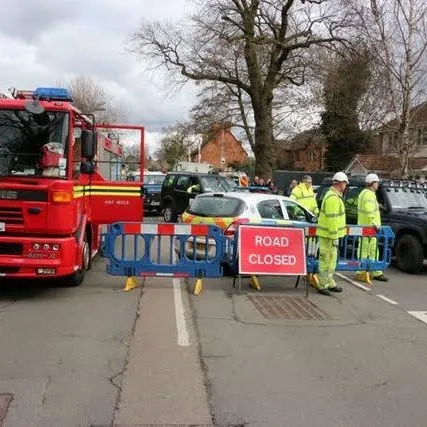 A road closure point with a fire appliance and responders in hi-vis